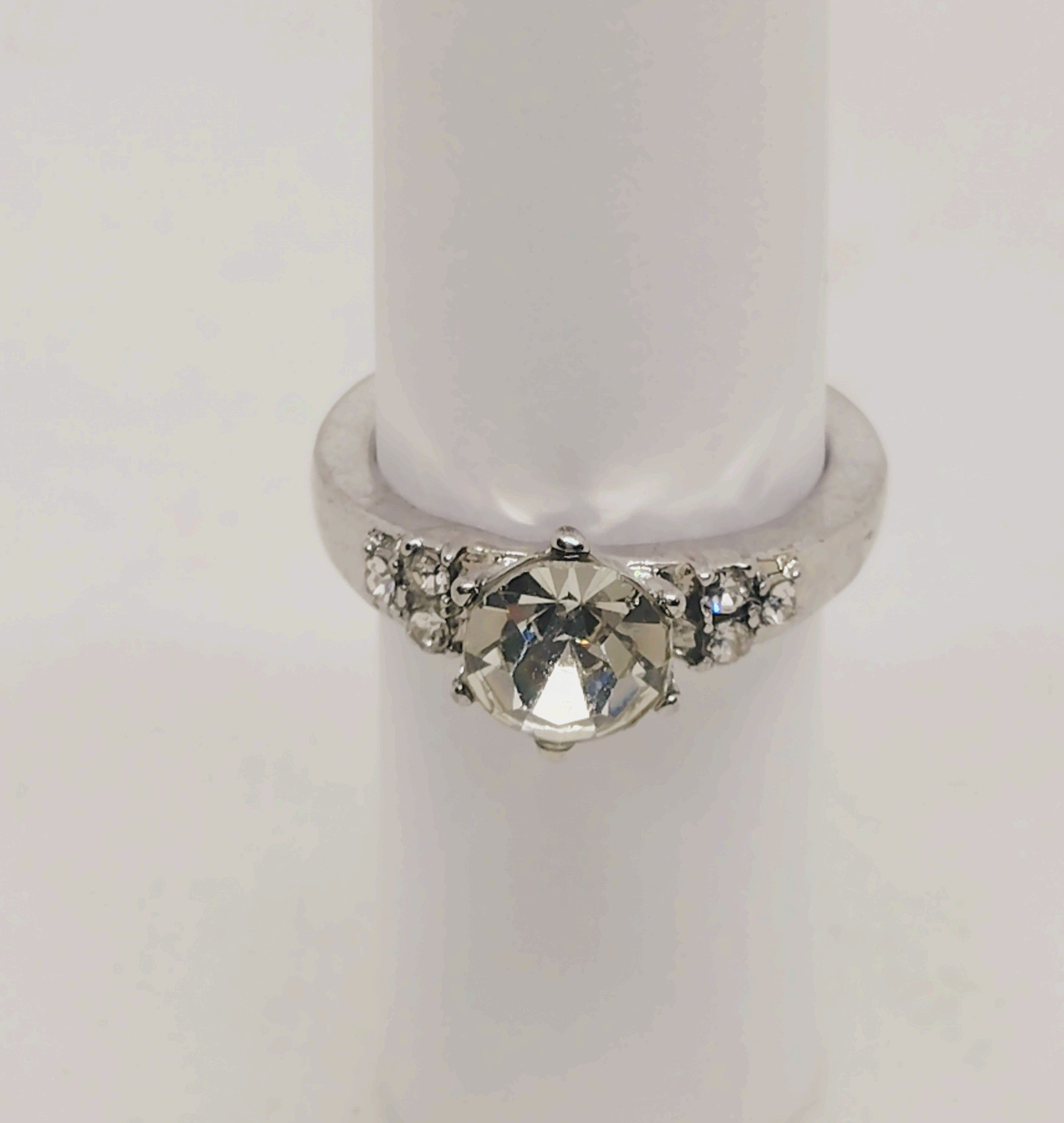 Dazzling Silver Solitaire Ring with Sparkling Accent Stones